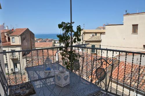 een tafel op een balkon met uitzicht op de stad bij Ferienwohnung für 5 Personen ca 75 qm in Cefalù, Sizilien Nordküste von Sizilien in Cefalù