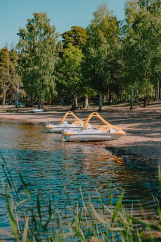 a group of boats sitting on the water at Hasselö Hostel in Hasselö