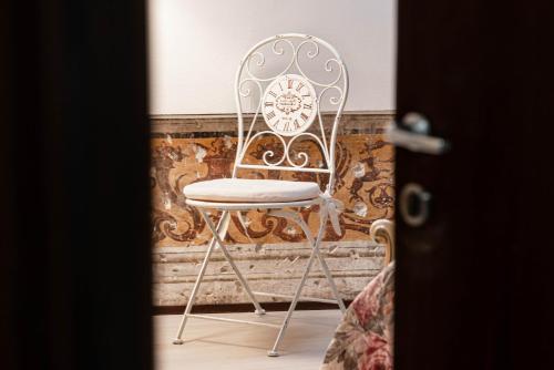 a chair sitting in front of a wall at Residenza Bra Verona in Verona