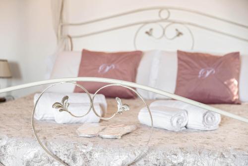 a bed with towels and slippers on it at Residenza Bra Verona in Verona
