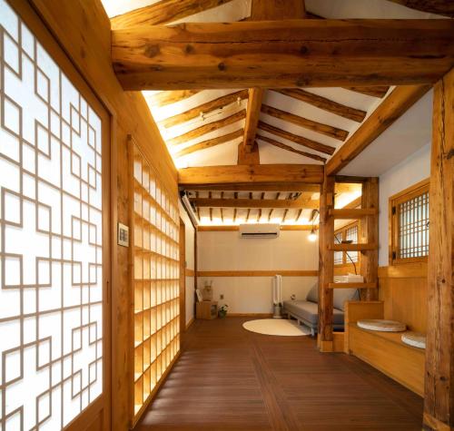 a large room with wooden floors and a large window at Luxury hanok with private bathtub - SW02 in Seoul
