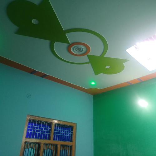 a ceiling with a ceiling fan and a window at Maa Durga niwas home stey in Ayodhya