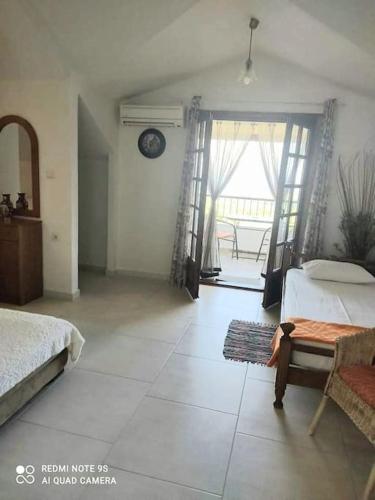 a bedroom with a bed and a table and a window at Thea apartments 3 in Platamonas