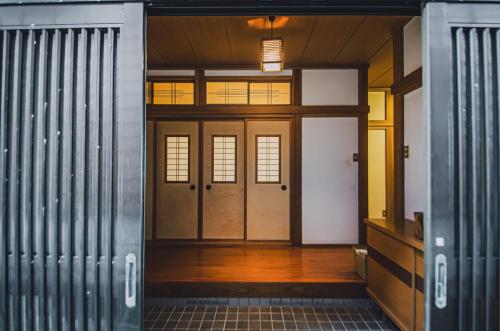 an entrance to a building with wooden doors at 【佐渡/一棟貸切】オーシャンビュー古民家SeaSideStory椿 離れ in Sado