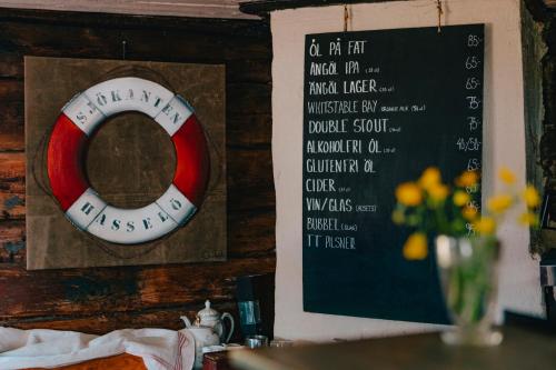 a sign on the wall of a restaurant with a life preserver at Hasselö Hostel in Hasselö