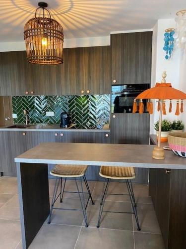 a kitchen with a large table and two chairs at Calpe Apolo V 3B Appartement Marrakech Style in Calpe