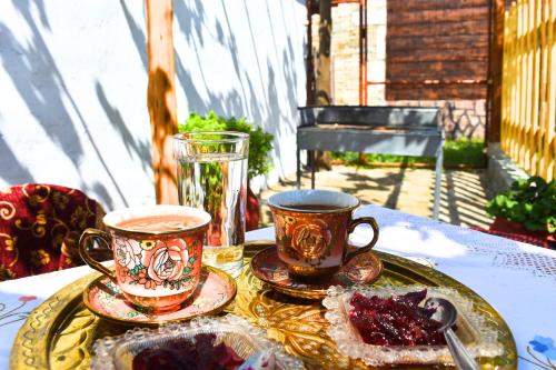 two coffee cups and a plate on a table at Kastro's View in Kalivia