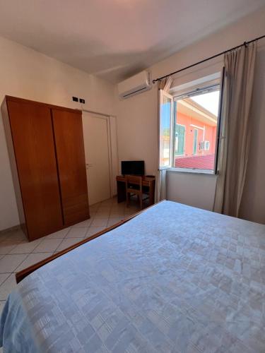 a bedroom with a large bed and a window at Locanda Maria in Ameglia