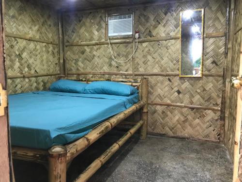a bed in a room with a shower at Bayview Coron Kawa Resort in Coron