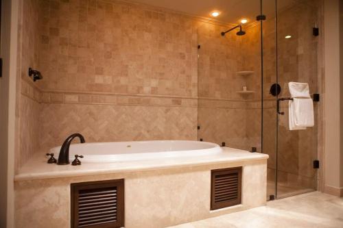 a bathroom with a tub and a glass shower at Four Fabulous 3BR Villa Unique View in Cabo in Cabo San Lucas