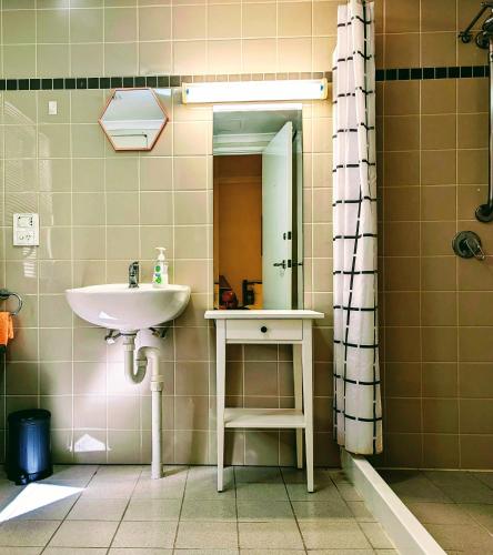a bathroom with a sink and a mirror at Kings Park Oasis with private courtyard, pool, free secure allocated parking and gym in Perth
