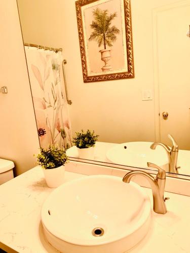 a white bathroom with a sink and a mirror at Watercreek-Four-bedroom house in Las Vegas in Las Vegas