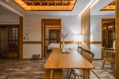 a dining room with a wooden table and chairs at Luxury hanok with private bathtub - SN04 in Seoul