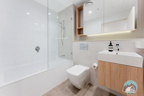 a bathroom with a toilet and a sink and a shower at Aircabin｜Wentworth Point｜Stylish Comfy｜2 Beds Apt in Sydney