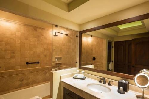a bathroom with a sink and a tub and a mirror at Incredible 3BR Ocean View Villa in Cabo San Lucas in Cabo San Lucas