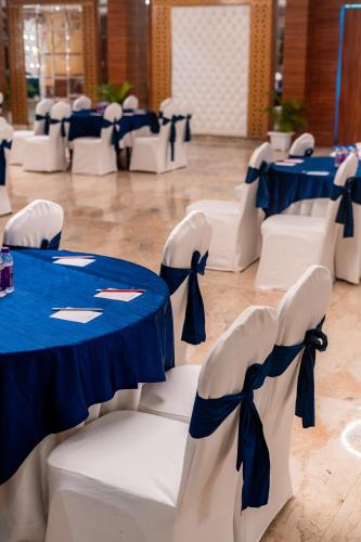 a room with blue and white tables and chairs at Playotel Resort Bhopal in Bhopal