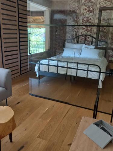 a bedroom with a bed in a glass room at Drinski Zen in Okletačko Polje