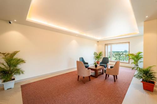 an empty waiting room with chairs and a table at Playotel Resort Bhopal in Bhopal