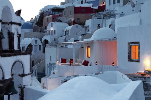 a view of a village with white buildings at Menias Cave House in Oia