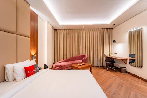 a hotel room with a bed and a desk at Playotel Resort Bhopal in Bhopal