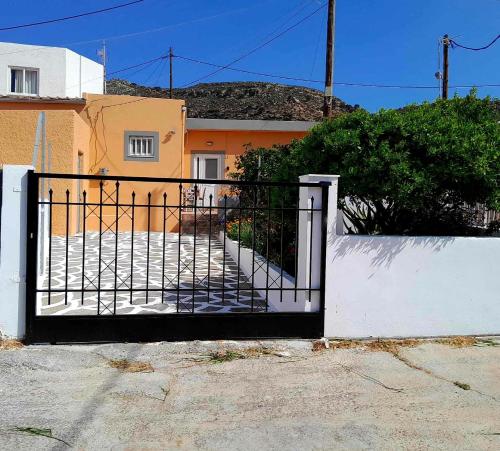 a black gate in front of a house at Katerina's House in Sitia