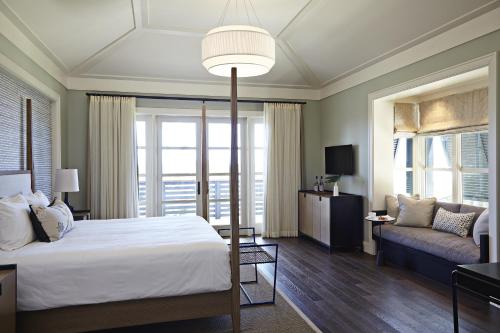 a bedroom with a large bed and a couch at The Island House in Nassau