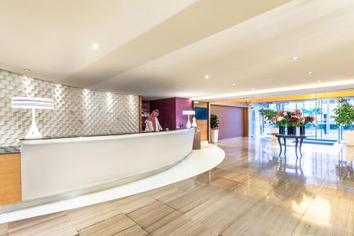 a lobby of a hotel with a reception counter at Novotel Suites Riyadh Olaya in Riyadh