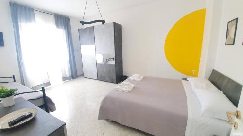 a bedroom with a bed and a table with a sink at Limited Edition Guesthouse in Bari