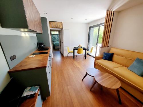 a living room with a couch and a table at Luxury Bali Villa in Hossegor 5 stars- Pool & Petanque in Hossegor