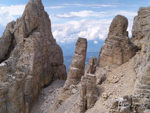 a view from the top of a mountain with tall rocks at Camera con bagno privato in Tesero