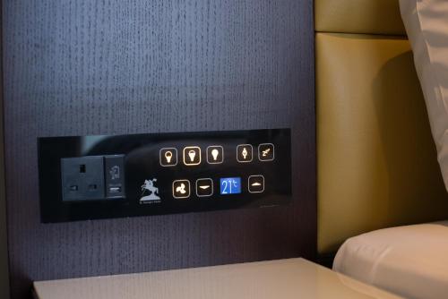 a control panel on the wall of a bedroom at St George's Hotel - Wembley in London
