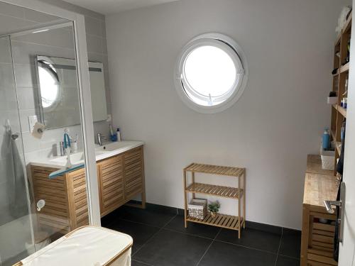 a bathroom with a shower and a sink and a mirror at Chambres 24h du Mans in Mulsanne