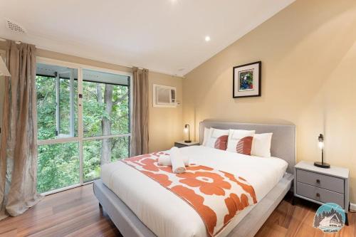 a bedroom with a large bed and a large window at Aircabin - Warrawee - Sydney - 5 Beds House in Warrawee