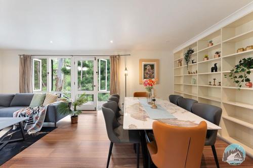 a dining room with a long table and chairs at Aircabin - Warrawee - Sydney - 5 Beds House in Warrawee
