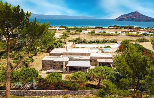 an aerial view of a garden with a mountain in the background at Luxury Villa Jolly in Paros Isterni in Isterni