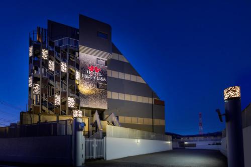 a building with a sign on it at night at Happy Kiss (Adult Only) in Showa
