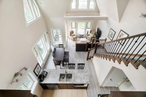 an overhead view of a living room with a staircase at Lakeview Majesty: Lavish 7-BR Penthouse Retreat With Rooftop Panorama in Harrison Hot Springs