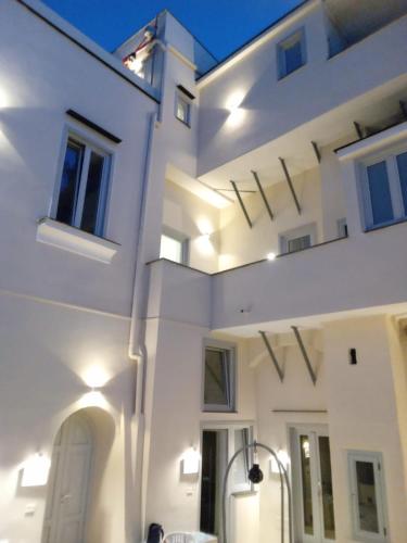 a white building with lights on the side of it at Palazzo Palumbo in Procida