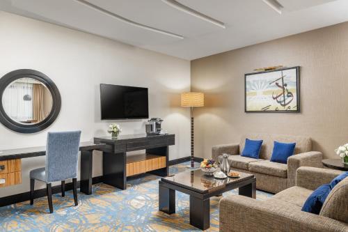 a living room with a couch and a table at Al Ghufran Safwah Hotel Makkah in Makkah