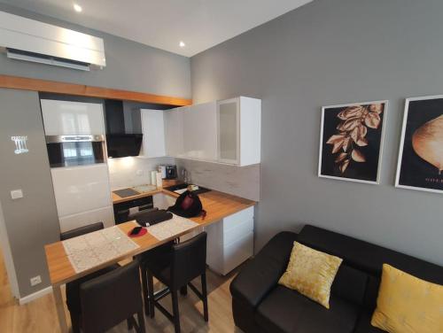 - une cuisine avec une table et un canapé dans une chambre dans l'établissement Appartement Centre Carmes, à Toulouse