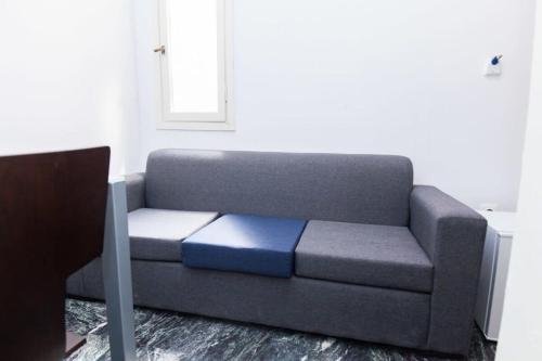 a couch in a living room with a blue cushion at Brand new 1 Bd Apt in Kolonaki in Athens