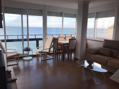 a living room with a couch and a table and chairs at Stunning views to the sea / City center Fuengirola in Fuengirola
