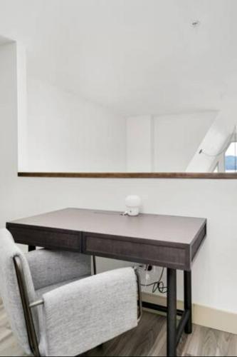 a desk with a chair in front of a mirror at Lakeview Splendor- 7BR Penthouse Bliss Combo unit in Harrison Hot Springs