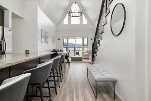 a living room with a row of chairs and a mirror at Lakeview Splendor- 7BR Penthouse Bliss Combo unit in Harrison Hot Springs
