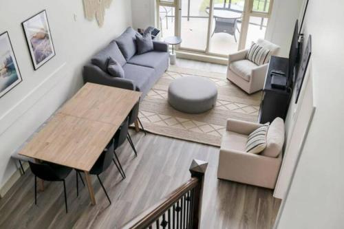 a living room with a couch and a table at Lakeview Splendor- 7BR Penthouse Bliss Combo unit in Harrison Hot Springs