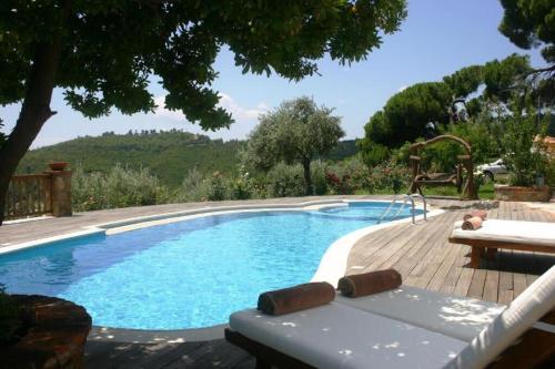 a swimming pool with a table and a bench next to it at Luxury Villa Nefeli w Private Pool In Skiathos in Troulos