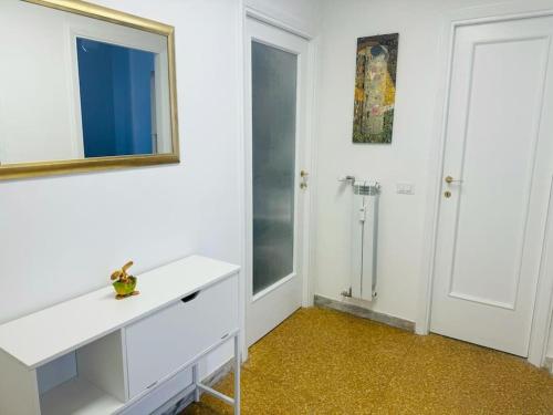 a white bathroom with a mirror and a sink at That's amoR in Rome