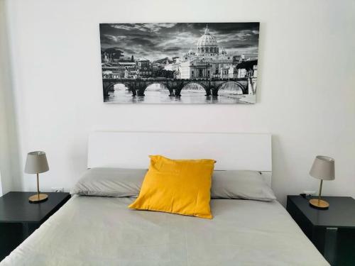 a bedroom with a yellow pillow on a bed at That's amoR in Rome