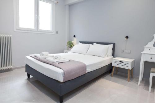a white bedroom with a bed and a desk at Athenian Comfort 1 Bd Apt Retreat next to Panormou in Athens