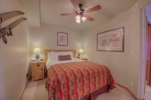 a bedroom with a bed and a ceiling fan at One BDR Ski in Ski Out Condo in Breckenridge